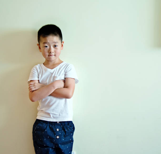 little boy against wall.